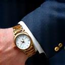 A man's wrist with a luxury watch, demonstrating elegant style
