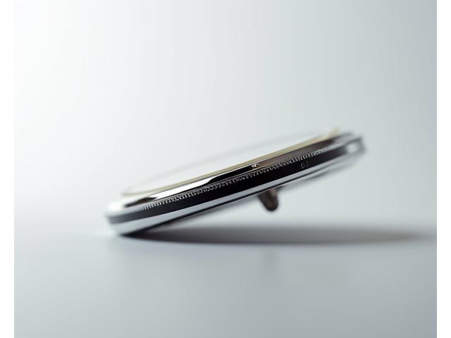 Close-up of an ultra-thin dress watch case, showcasing its slim profile and intricate finishing.